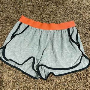 Grey track shorts with black outline and orange waist band